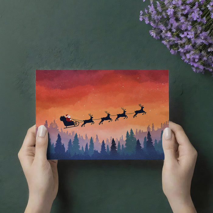 Arctic Twilight Sleigh Ride Mural Wallpaper | Warm Orange Sky, Blue Forest Silhouettes, Serene