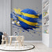 A bright nursery featuring the soccer mural as a dynamic accent wall behind a wooden bed frame.