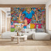 Bold soccer mural wallpaper featured in a dedicated media room with dark furniture and large display screens.