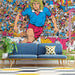 Vintage sports mural wallpaper installed on the main wall of a teen boy's bedroom with modern minimalist furniture.