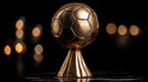 Bronze soccer ball trophy on a dark background with blurred lights