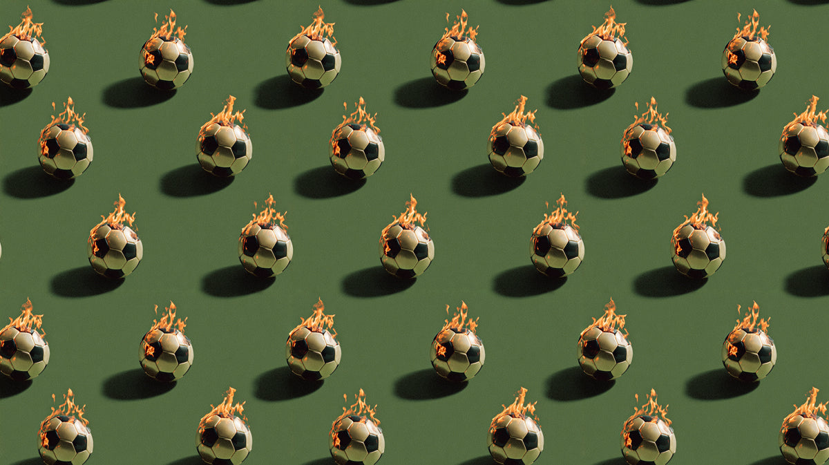 Repeating pattern of soccer balls with orange flames against a flat olive green background.