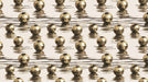 Pattern of gold beads on a reflective surface