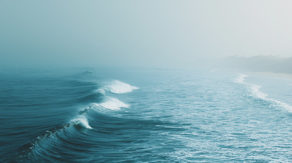 Serene Foggy Beach Waves Mural Wallpaper | Cool Teal Hues, Repetitive Motion, Minimalist Coastal Scene