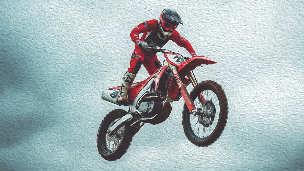 Motocross rider in mid-air performing a stunt on a red motorcycle against a light blue textured background