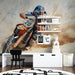 Room interior with a wall mural of a motocross rider, shelves with decor items, and a rug with road patterns.
