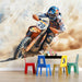 Motocross rider on a bike with colorful chairs and blocks in the foreground