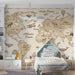 A cozy nursery room wall covered in a vintage map mural with neutral wood accents and soft lighting.