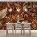 Warmly lit living room featuring a feature wall of acanthus scrollwork wallpaper behind a dark leather sofa.