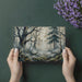 Library or reading nook featuring an atmospheric forest wall mural and warm vintage lighting