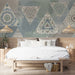 Bohemian mandala triangle mural installed on a bedroom feature wall behind a upholstered bed frame.