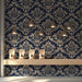 Sophisticated home library featuring a floor-to-ceiling damask wall mural behind dark wood shelving.