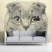 Hand-drawn feline wall art in a stylish reading room with comfortable armchair