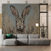 A tranquil reading nook featuring the hare painting mural, accented by a neutral armchair and warm, soft lighting.