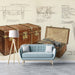 Vintage travel trunk mural installed behind a leather desk in a home study.