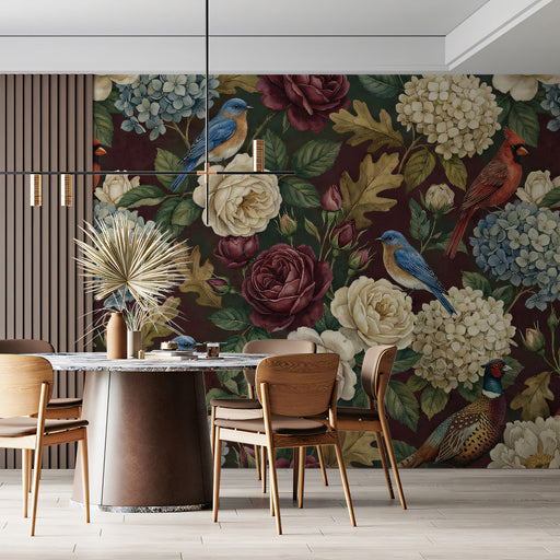 Moody floral bird wallpaper installed as a feature wall in a cozy home library with dark wood shelving