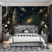 A creative bedroom design featuring a dark celestial mural behind a minimalist metal bed frame.