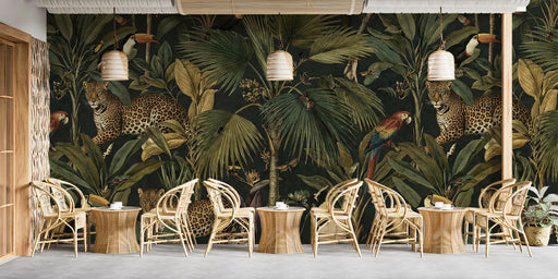 Moody tropical jungle wallpaper installed in a cozy bedroom with velvet decor