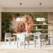 An atmospheric dining room setting featuring the artistic bird mural on a main wall.