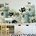 A bright, cheerful child's bedroom featuring the cat castle wallpaper on the main wall.