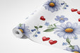 Playful heart and flower pattern wallpaper used in a bright breakfast nook with simple dining furniture.