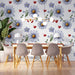 Soft floral and heart motif wallpaper creating a happy atmosphere in a child’s playroom with colorful toys.