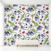 Whimsical bluebell wallpaper installed in a bright and cozy nursery room