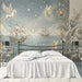 A serene reading nook with a velvet armchair set against the dreamlike fairy and sailing ship mural