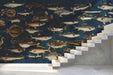 Navy blue fish mural installed in a sophisticated home office with dark wood bookshelves