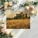A formal dining room decorated with a wall-to-wall mural of a medieval castle overlooking a harvest landscape