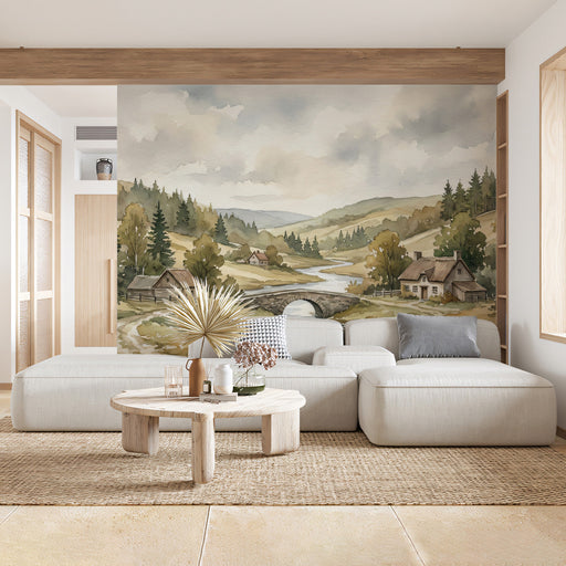 A cozy living room featuring the countryside bridge mural behind a beige sofa and wooden coffee table.