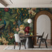 Grand entryway wall decorated with an intricate, colorful tropical forest wallpaper mural