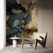 Moody bedroom with a surreal botanical portrait mural featuring deep blue and warm earth tones