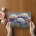 Close-up of floral wall mural in a bright, modern living room with neutral furniture