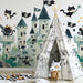 A children's bedroom featuring the playful cat pirate castle wallpaper on the main wall