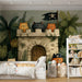 A cozy nursery featuring the pirate cat castle mural behind a white wooden crib