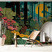 A whimsical nursery room wall decorated with a bold, colorful forest and flower pattern.