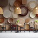 Geometric earth-tone wallpaper installed in a modern living room with neutral furniture.