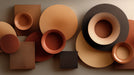 Abstract wallpaper pattern with overlapping circles and squares in terracotta, ochre, and charcoal.