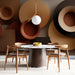 Modern geometric circle design on the wall of a home office with minimalist desk and decor.