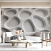 Contemporary hotel lobby with a bright white organic wall design and soft lighting