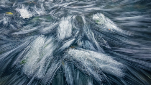 Abstract wallpaper pattern with sweeping white brushstrokes over a deep slate and charcoal background.