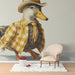 A playful nursery room wall decorated with a dapper duck mural, creating a fun and creative environment for children.