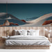 Living room interior featuring a desert dune mural wallpaper behind a minimalist cream sofa