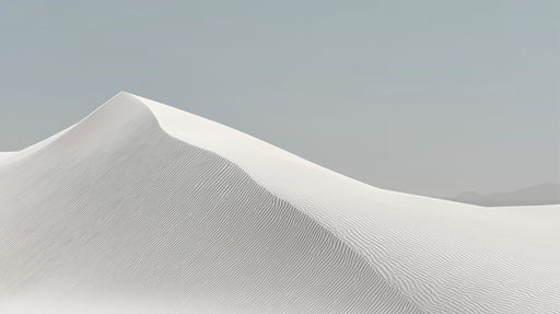 A clean, minimalist mural of a white sand dune with fine ripple textures under a soft, muted gray sky.