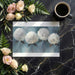 Large-scale botanical wallpaper backdrop for a refined dining room with wooden furniture.