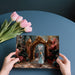 A romantic bedroom featuring the gilded garden gate mural behind a plush headboard.