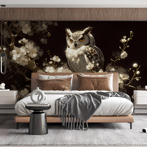 A dimly lit dining room wall decorated with a large-scale nocturnal owl and blossom wallpaper mural.