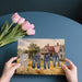 Dining room with pastoral watercolor wallpaper showing a sunny rural scene