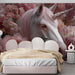 Whimsical unicorn floral mural as a decorative feature wall in a cozy home reading room.